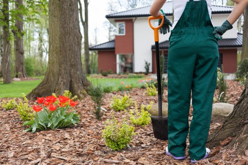 Operative inspecting a garden as part of a risk assessment